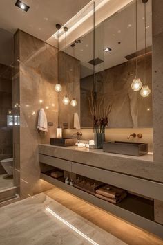 a bathroom with a sink, mirror and lights on the wall in front of it