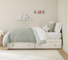 a bedroom with white walls and wooden floors