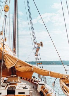 an image of a person on the deck of a boat that is sailing in the water