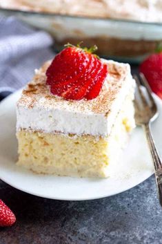 a piece of cake on a plate with strawberries