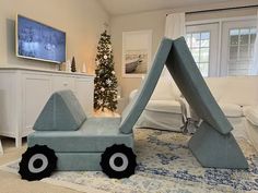 a living room filled with furniture and a christmas tree