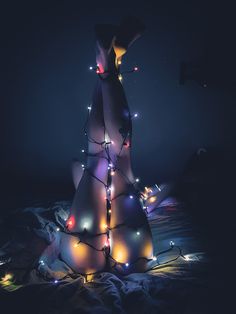 a christmas tree with lights on it in the dark