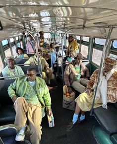 several people sitting on a bus with food in their hands