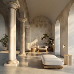 an empty room with columns and white furniture