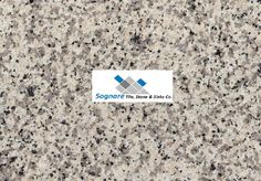 the logo for sonate tile and stone co on top of a granite countertop