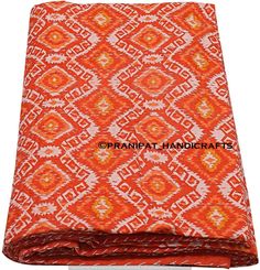 an orange and white patterned blanket