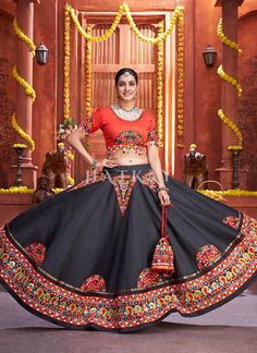 Red And Black Kutchi Embroidered Rajwadi Chaniya Choli is feminine, appealing and excellent pick for this Navratri festival. This elegant set has a very pretty kutchi embroidery enhanced with patch work, multi dori and mirror work detail on flared art silk chaniya/lehenga paired with equally embellished art silk choli and fascinating multi embroidered and tasseled art silk dupatta. Team this beautiful attire with classic pair of heels and matching jewellery to look like a diva. Shop Designer Cha Kachi Work Chaniya Choli, Navratri Chinon Choli With Multicolor Embroidery, Black Resham Embroidery Choli For Navratri, Traditional Navratri Choli With Intricate Embroidery, Black And Red Chaniya Choli For Navratri, Black Embroidered Choli For Navratri, Kachi Work, Kutchi Embroidery, Navratri Festival