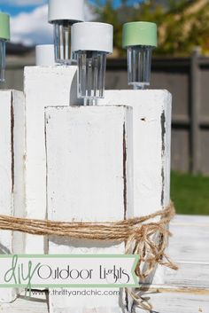 three bottles tied up on top of a wooden table