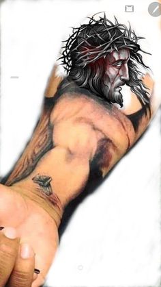 a man's arm with a tattoo on it and his hand holding the wrist