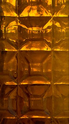 an orange glass block with some yellow squares on it