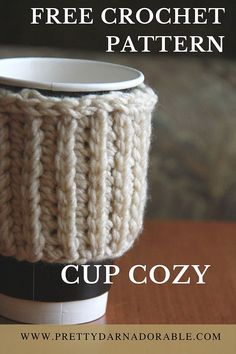 a knitted cup cozy with the text free crochet pattern on top and bottom