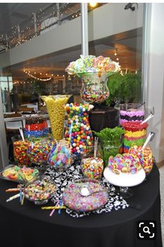 a table topped with lots of candy and lollipops on top of it