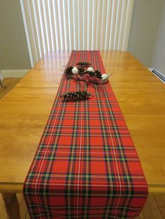 Accent your Christmas table with this Royal Stewart tartan table runner. Top with a greenery centerpiece and your table will sparkle. The Royal Stewart runner is made of poly viscose fabric with a coordinating rolled hem edging. The runner is washable. The fabric is the same on both sides.You can choose the size that best works for you. If you do not see the size that you need we enjoy doing custom orders. Matching placements and napkins are also available.Also available are the following tartan Royal Stewart Tartan, Greenery Centerpiece, Stewart Tartan, Rolled Hem, Viscose Fabric, Christmas Table, Table Runner, Table Runners, Custom Orders