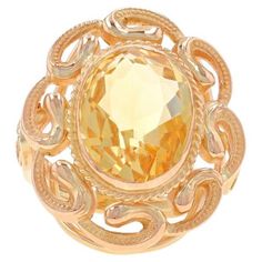 Size: 5 1/4 Sizing Fee: Up 2 sizes for $45 or Down 1 size for $45 Era: Retro Date: 1940s - 1950s Metal Content: 14k Yellow Gold Stone Information Natural Citrine Treatment: Heating Carat(s): 5.20ct Cut: Oval Color: Yellow Total Carats: 5.20ct Style: Cocktail Solitaire Theme: Floral Swirl Measurements Face Height (north to south): 31/32" (24.4mm) Rise Above Finger: 5/16" (7.3mm) Weight: 7.0 Grams Stamps: 14k Condition: Pre-Owned Retro Cocktail, La Face, Gold Stone, Solitaire Ring, Citrine, Swirl, Metallica, Jewelry Rings, Yellow Gold