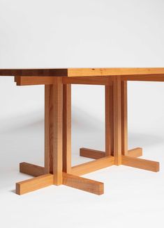 a wooden table sitting on top of a white floor