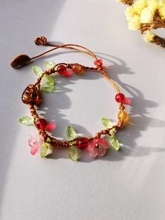 a bracelet with flowers and leaves on it