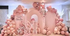 an elaborately decorated stage with balloons and flowers