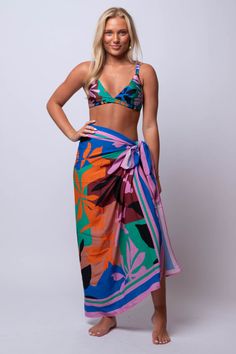 Unleash your inner beach goddess with our Ananya SARONG. Versatile and beachy, this sarong is perfect for all your summer adventures. Go from beach to bar in style with this must-have accessory. Fit Guide: One Size *available at our bandit location Summer Swimwear With Vibrant Print For Festival, Summer Festival Swimwear With Vibrant Print, Multicolor Wrap Sarong For The Beach, Multicolor Wrap Sarong For Beach, Vacation Beach Cover-up Sarong, Multicolor Sarong For Beach Cover-up, Multicolor Tropical Print Sarong For Summer, Vibrant Triangle Top Swimwear For Beach, Bohemian Pink Swimwear For Vacation