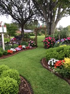 a lush green yard with lots of flowers