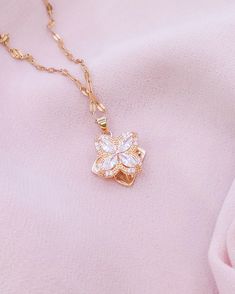 Embrace the grace of spring with our Blossoming Charm Necklace, featuring a delicate crystal flower pendant that sparkles with every turn. Suspended from a dainty gold chain, this necklace is a versatile piece that brings a touch of nature's beauty to your ensemble. It's perfect for layering or wearing solo as a subtle, yet enchanting statement. Need help? Want to purchase a bulk order? Get in touch! ~ Email: contact.aurumgrace@gmail.com ~ Instagram: @AurumGrace All images are copyrighted by Aur Elegant Mother's Day Pendant Crystal Necklace, Feminine Necklace With Flower Pendant For Her, Feminine Necklace With Flower Charm, Feminine Necklace With Flower Pendant As Gift For Her, Feminine Flower Pendant Necklace With Clavicle Chain, Feminine Flower Pendant Necklace Gift For Her, Feminine Flower Pendant Necklace As Gift For Her, Rose Gold Crystal Jewelry With Flower Shape, Rose Gold Crystal Flower-shaped Jewelry