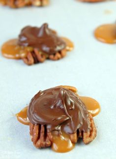 chocolate covered cookies with caramel drizzled on top are sitting on a baking sheet