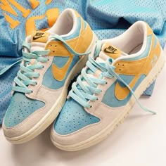 a pair of blue and yellow nike sneakers