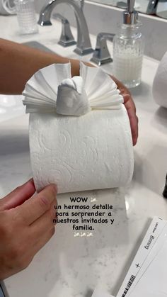 a person is holding a roll of toilet paper