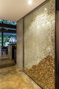 the interior of a modern house with large glass walls and wood chips in front of it