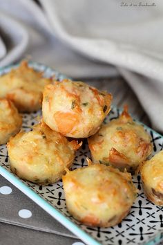 small appetizers on a blue and white plate with polka dot napkin in the background