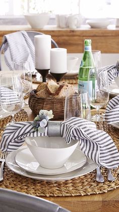 the table is set with dishes and silverware