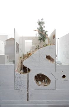 a white building with holes in the side and trees growing out of it's walls