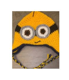 a crocheted yellow and black hat with eyes