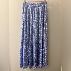 New With Tags Cottagecore Peasant Skirt, Blue With Daisy Print. Perfect For The Farmers Market Or Brunch On The Weekends. 40 Inches Long, Elastic Waist With Zip And Clasp. Great Condition! Smoke Free Home. Check Out My Closet And Ask Me About A Bundle! Reasonable Offers Considered! Pictured Is The Actual Item. Please Review All Pictures Carefully, As They Are Part Of The Description. Ask Question Prior To Purchase. I Am Happy To Give More Detail! Items Shipped Same Day Or Next Day, When Able. No Blue Flowy Floral Print Bottoms, Blue Floral Print Tiered Maxi Skirt, Casual Flowy Blue Skirt, Casual Blue Flowy Skirt, Flowy Blue Tiered Skirt, Spring Blue Flowy Skirt, Blue Flowy Skirt For Spring, Blue Floral Print Long Skirt, Blue Flowy Midi Skirt