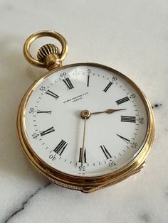 This superb collectible vintage ladies Patek Philippe open face pocket watch is a true luxury item for any watch enthusiast. Crafted from 18 carat yellow gold, the watch features a classic white dial face with a Roman numeral12-hour dial, a signed case and 67722 serial number. With a case diameter of 4.8cm and weighing 33.45 grams, this fob/ pocket watch is a perfect addition to any collection. The exquisite yellow gold case and features make it stand out from other watches, and it is sure to be Patek Philippe Pocket Watch, Fancy Watches, Clock Repair, Bridesmaid Boxes, Vintage Pocket Watch, Open Face, Vintage Clock, Gold Case, Luxury Watches For Men