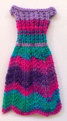 a colorful knitted dress hanging on the wall