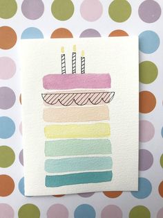 a piece of paper with a cake on it and candles in the middle, surrounded by polka dots