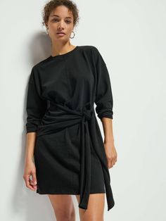 This no-fuss drop-shoulder wrap dress is just what you've been looking for. A relaxed fit crew neck with a contrast neckband, shirring at the waist, and a tie to cinch in as much or as little as you want. Complete the look with your favorite knee-highs and prepare to turn some heads. (This one comes in Jet Black.) | Gloria Dress in Jet Black | Ethical Essentials Wrap Front Dress, Nation Ltd, Knee Highs, Shoulder Wrap, High Knees, Jet Black, Drop Shoulder, Neck Tie, Wrap Dress