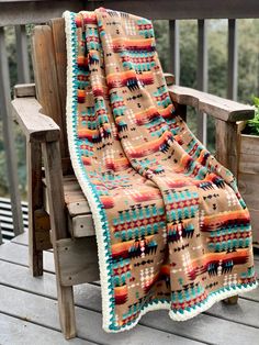 a blanket sitting on top of a wooden bench