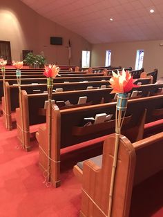 rows of wooden pews with flowers in them