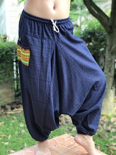 "Thai Cotton Harem Pants Unisex Low Crotch Yoga Trousers Comfort and character are what these pants are all about. They have the traditional sarong look & feel but a lot more practical when it comes to activity like yoga. Together with elastic cuff legs, you can wear them short or long. The pants have Rope waist with elastic (wide bang elastic) with pocket. The fabric is exceptionally soft, light, and airy, ideal for those warm days. If it's a bit chilly, you could always wear leggings under Cotton Harem Yoga Pants With Pockets, Blue Cotton Harem Pants With Pockets, Blue Tapered Leg Harem Pants With Pockets, Bohemian Harem Pants With Pockets And Tapered Leg, Festival Yoga Pants With Pockets, Baggy Harem Pants With Side Pockets, Blue Cotton Harem Pants With Side Pockets, Blue Hippie Pants With Pockets, Hippie Blue Bottoms With Pockets