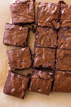 chocolate brownies cut into squares on a piece of parchment paper