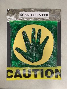 there is a sign that says caution with a hand in the center and yellow tape around it