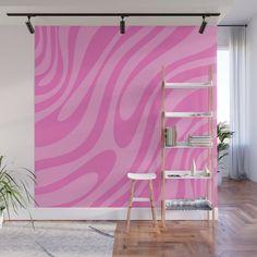 a pink and white wall mural in a living room with a ladder leaning against the wall