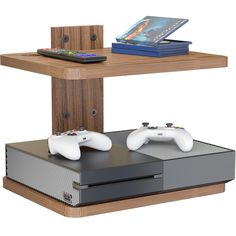 two video game controllers sitting next to each other on a table with a remote control