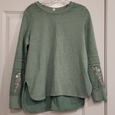 Soft Green Sweatshirt With Embroidered Sleeves. Never Worn. Like New. Size Small Green Embroidered Long Sleeve Tops, Casual Green Sweater With Embroidered Graphics, Casual Long Sleeve Sweater With Floral Embroidery, Casual Embroidered Long Sleeve Tops, Green Long Sleeve Top With Floral Embroidery, Green Floral Embroidered Tops For Fall, Green Floral Embroidery Tops For Fall, Relaxed Fit Embroidered Tops For Loungewear, Spring Long Sleeve Tops With Embroidered Graphics