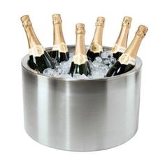 six bottles of champagne in an ice bucket