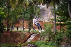 a man flying through the air while riding a skateboard in front of other people