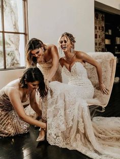 three bridesmaids laughing together on the floor