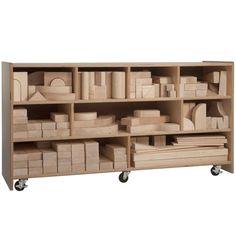 a wooden shelf filled with lots of boxes and drawers on casteors to the side