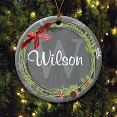 a personalized christmas ornament hanging on a tree